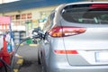 Refueling refilling car vehicle with fuel at refuel fuel gas pump station - Petrol diesel gas pump gun in the tank to fill -