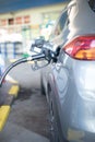 Refueling refilling car vehicle with fuel at refuel fuel gas pump station - Petrol diesel gas pump gun in the tank to fill - Royalty Free Stock Photo