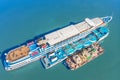 Refueling at sea - Small Oil products ship fuelling a large Bulk carrier, aerial image.