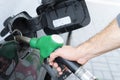 Refuelling the car at a gas station fuel pump. Man driver hand refilling and pumping gasoline oil the car with fuel at he refuel s Royalty Free Stock Photo