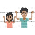 Refugee boy and girl behind barbed wire