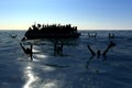 Refugees on a big rubber boat in the middle of the sea that require help Royalty Free Stock Photo