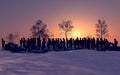 Column of migrants crossing desolate and snow-covered lands in the night. Silhouette. Refugees and immigrants