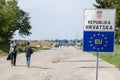 Refugees passing in front of the EU entrance sign in front of the Serbia-Croatia border crossing of Sid Tovarnik