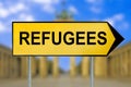 Refugees traffic sign with blurred Berlin background