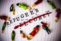 Refugees welcome strikethrough text on paper