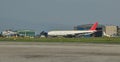 Refurbished airline in front of hangar building at Nepal Tribhuvan International Airport