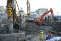 Refurbishment of the Pochtovaya square, concrete hydraulic static pile driver, digger and builders working