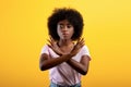 Refusal concept. Upset black lady showing stop gesture with crossed hands, refusing something unwanted Royalty Free Stock Photo