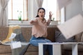 Refusal of deal. Young Caucasian woman sitting on sofa screams and throws documents into camera. Business and mortgage Royalty Free Stock Photo