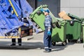 refuse collection worker loading garbage for trash removal