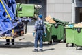 refuse collection worker loading garbage for trash removal