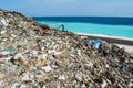 Refuse at the garbage dump near the ocean full of smoke, litter, plastic bottles,rubbish and trash at tropical island Royalty Free Stock Photo