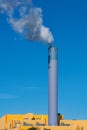 Refuse incineration plant with a smoking chimney Royalty Free Stock Photo