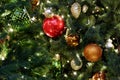 Reg, gold, green and silver christmas decorations on a christmas tree with lights Royalty Free Stock Photo