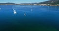 Regatta in Gelendzhik Bay. A lot of small one-and two-person yachts jostle in the Bay with a light wind. The view from