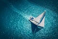 Regatta sailing ship yachts with white sails at opened sea. Aerial view of sailboat in windy condition