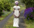 Regency woman in a cream dress, paisley shawl and bonnet