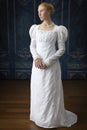 A Regency woman wearing a white cotton muslin dress and standing in a room Royalty Free Stock Photo