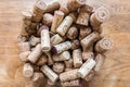 Many wine corks of different wines in a large glass champagne cooler