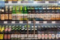 Regensburg, Germany - 2021 02 05: Refrigerated section with bottles of various german craft beer brands behind glass doors on