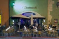 People have late dinner in a street cafe in Regensburg, Germany.