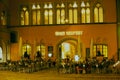 People have late dinner in a street cafe in Regensburg, Germany.