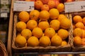 Regensburg, Germany - 2021 02 05: Unpacked organic oranges and clementines in basket with price tag on display in organic super