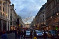 Regent Street with Christmas lights crowded with people. London, United Kingdom.