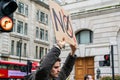 REGENT STREET, LONDON, ENGLAND- 20 March 2021: Protester holding an anti-vax placard at an anti-lockdown protest