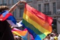 Onlooker celebrating and waving LGBT rainbow flag during the Gay Pride Parade, London 2018.