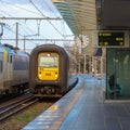 Regional Train in the station Bruges with clock Royalty Free Stock Photo