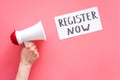 Register now hand lettering icon near megaphone on pink background top view copy space
