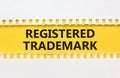 Registered trademark symbol. Concept word Registered trademark on yellow and white paper. Beautiful yellow and white background.