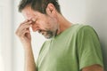 Regretful man alone in living room