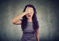 Regretful woman covering her eyes Royalty Free Stock Photo