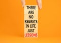 Regrets or lessons symbol. Concept words There are no regrets in life just lessons on wooden blocks on a beautiful orange Royalty Free Stock Photo