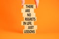 Regrets or lessons symbol. Concept words There are no regrets in life just lessons on wooden blocks on a beautiful orange Royalty Free Stock Photo