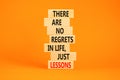 Regrets or lessons symbol. Concept words There are no regrets in life just lessons on wooden blocks on a beautiful orange table Royalty Free Stock Photo