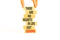 Regrets or lessons symbol. Concept words There are no regrets in life just lessons on wooden blocks on a beautiful white Royalty Free Stock Photo