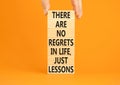 Regrets or lessons symbol. Concept words There are no regrets in life just lessons on wooden blocks on a beautiful orange Royalty Free Stock Photo