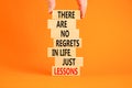 Regrets or lessons symbol. Concept words There are no regrets in life just lessons on wooden blocks on a beautiful orange Royalty Free Stock Photo
