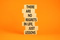 Regrets or lessons symbol. Concept words There are no regrets in life just lessons on wooden blocks on a beautiful orange table Royalty Free Stock Photo