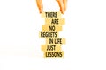 Regrets or lessons symbol. Concept words There are no regrets in life just lessons on wooden blocks on a beautiful white Royalty Free Stock Photo