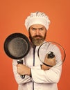 Regular cooking. Preparing food in kitchen. Cooking food concept. High quality frying pan. Bearded man cook white Royalty Free Stock Photo