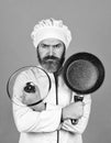 Regular cooking. Preparing food in kitchen. Cooking food concept. High quality frying pan. Bearded man cook white