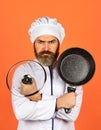 Regular cooking. Preparing food in kitchen. Cooking food concept. High quality frying pan. Bearded man cook white Royalty Free Stock Photo