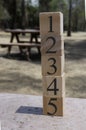 Numbers from 1 to five on some wooden cubes in the park