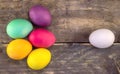 Regular egg against painted Easter eggs on a wooden table. Happy Royalty Free Stock Photo