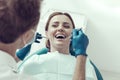 Happy patient looking at her dentist